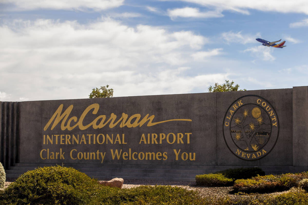 A sign for McCarran International Airport with a plane taking off above it at Tropicana Avenue ...