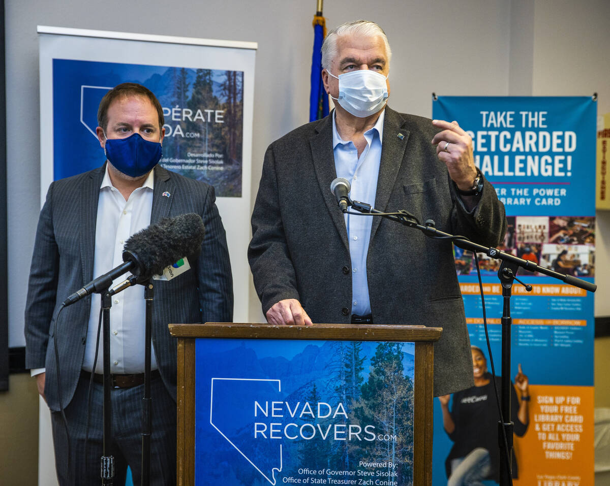 Governor Steve Sisolak, right, speaks beside Nevada Treasurer Zach Conine as they conclude the ...