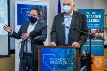Nevada Treasurer Zach Conine, left, speaks beside Governor Steve Sisolak as they conclude the N ...
