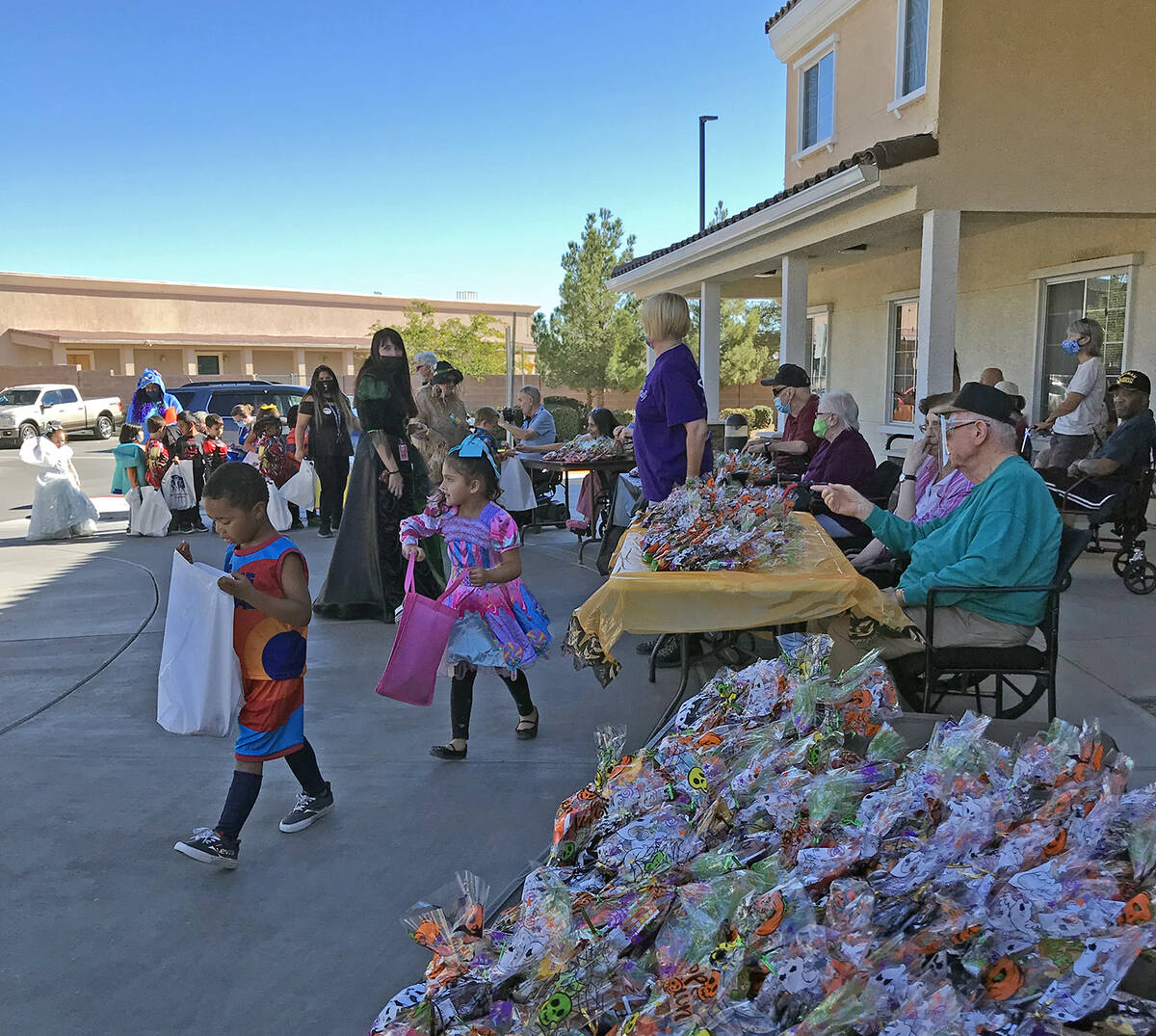 Robin Hebrock/Pahrump Valley Times One young student can be seen peering into his Halloween bag ...