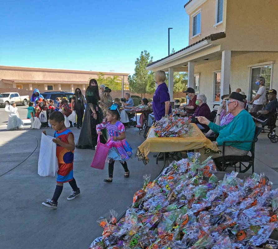Robin Hebrock/Pahrump Valley Times One young student can be seen peering into his Halloween bag ...