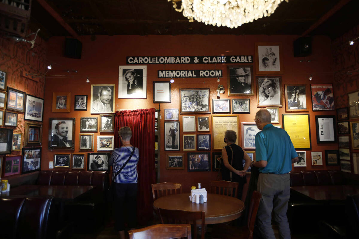 Customers see the photos of Clark Gable and Carole Lombard at the Pioneer Saloon, Thursday, Oct ...