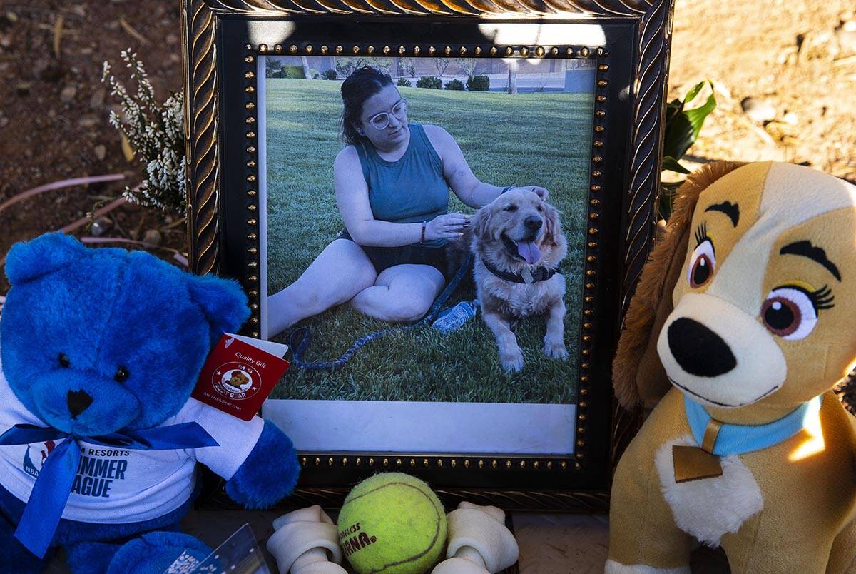 A photograph of Tina Tintor, 23, and her dog Max is placed at a makeshift memorial site to hono ...