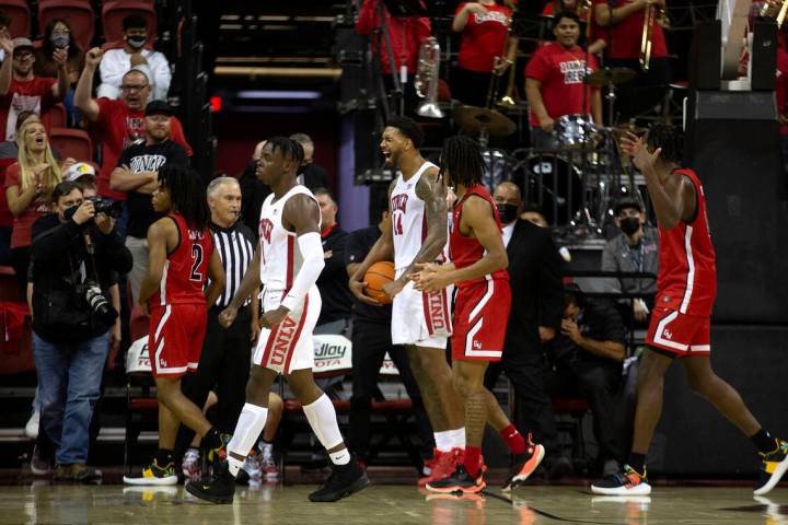 UNLV Rebels forward Royce Hamm Jr. (14) and guard Mike Nuga (1) celebrate a blocked point by Ha ...