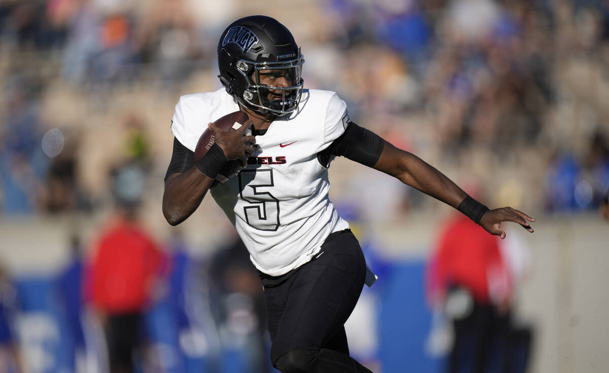 UNLV quarterback Justin Rogers runs for a short gain against Air Force in the first half of an ...
