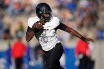 UNLV quarterback Justin Rogers runs for a short gain against Air Force in the first half of an ...