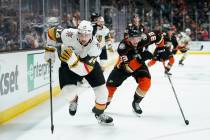 Vegas Golden Knights' Nicolas Hague, left, skates past Anaheim Ducks' Jakob Silfverberg while c ...
