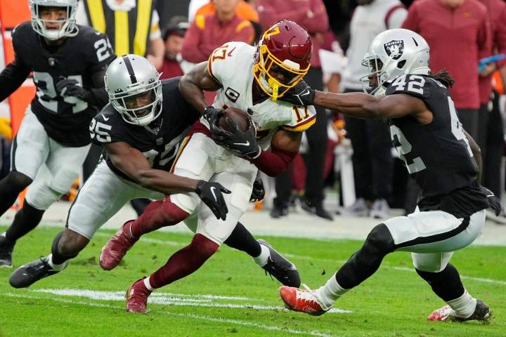 Las Vegas Raiders outside linebacker Cory Littleton (42) tackles Washington Football Team wide ...