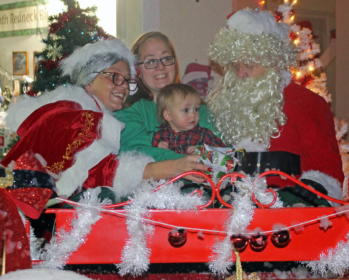 Robin Hebrock/Pahrump Valley Times Santa and the missus are seen taking photos with a local fam ...
