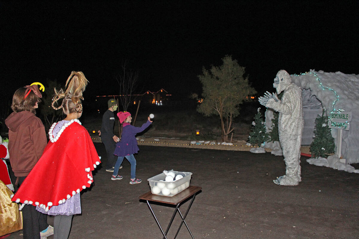 Robin Hebrock/Pahrump Valley Times A young girl hurls a snowball at the Abominable Snowman whil ...