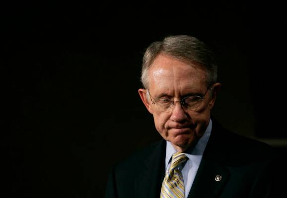 Senate Majority Leader Harry Reid, D-Nev., listens to a reporter's question during a news confe ...