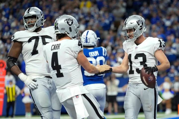 Las Vegas Raiders wide receiver Hunter Renfrow (13) celebrates with teammate quarterback Derek ...