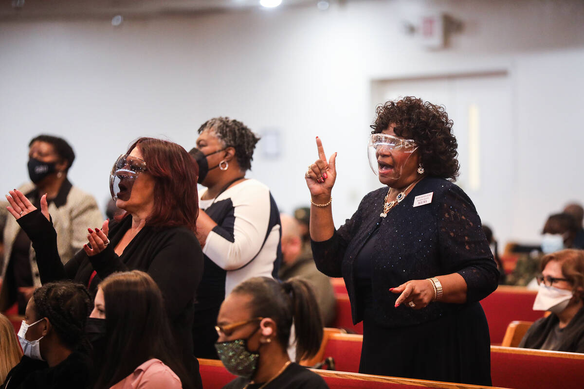 Members of the congregation dance with the music during a service honoring Dr. Martin Luther Ki ...