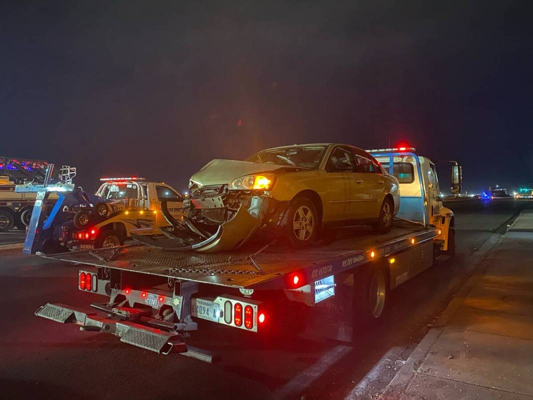 A vehicle that was involved a six-vehicle crash is towed away from the scene of a fatal acciden ...