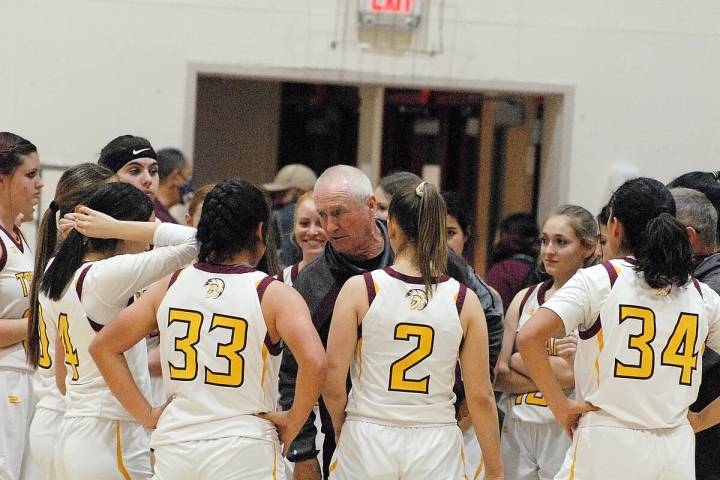 Pahrump Valley Trojans' head coach Bob Hopkins talking to his team during a timeout against Eld ...