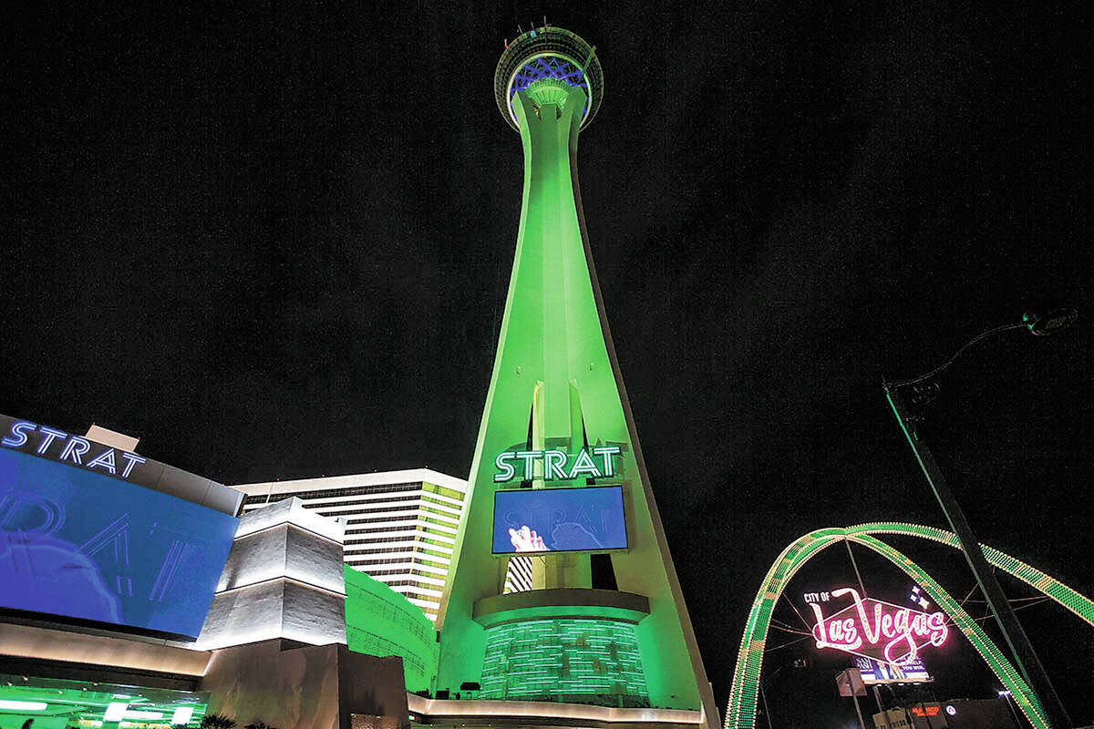 The STRAT and the Las Vegas Boulevard Gateway Arches are lit green for St. Patrick's Day on Wed ...