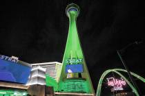 The STRAT and the Las Vegas Boulevard Gateway Arches are lit green for St. Patrick's Day on Wed ...