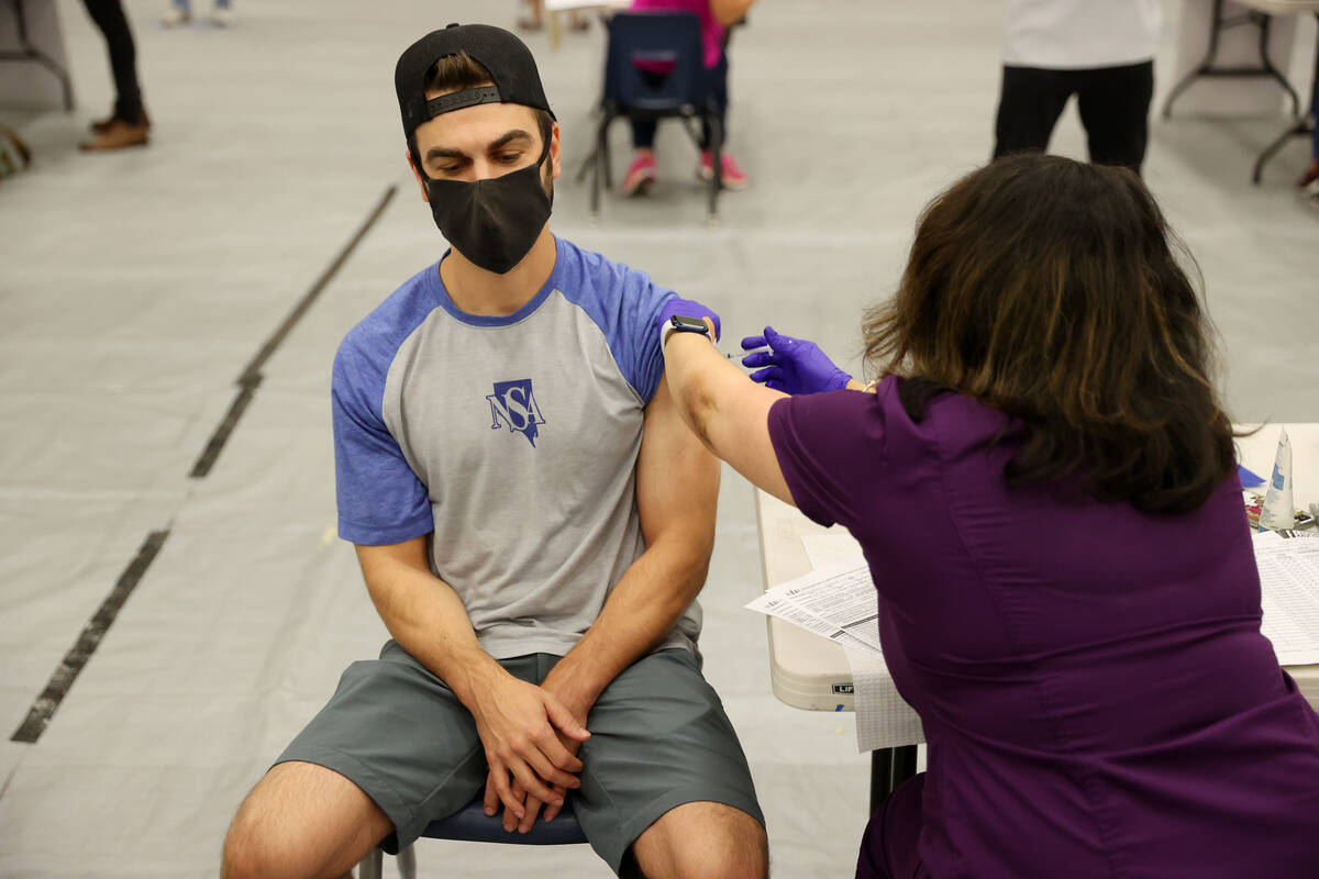 Keenan Laffoon of Las Vegas receives the COVID-19 vaccine during a pop-up vaccination clinic at ...