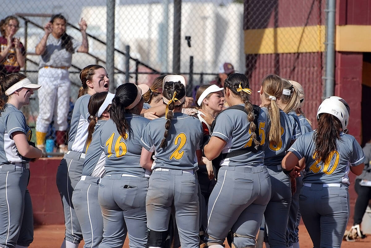 Horace Langford Jr./Pahrump Valley Times The Pahrump Valley Trojans celebrate at home plate af ...