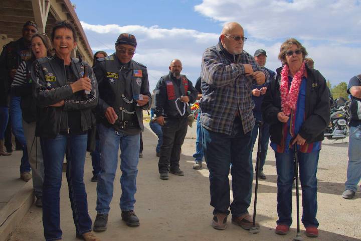 In front of the Bounty Hunter Saloon, participants of the 100-mile run listen for their raffle ...