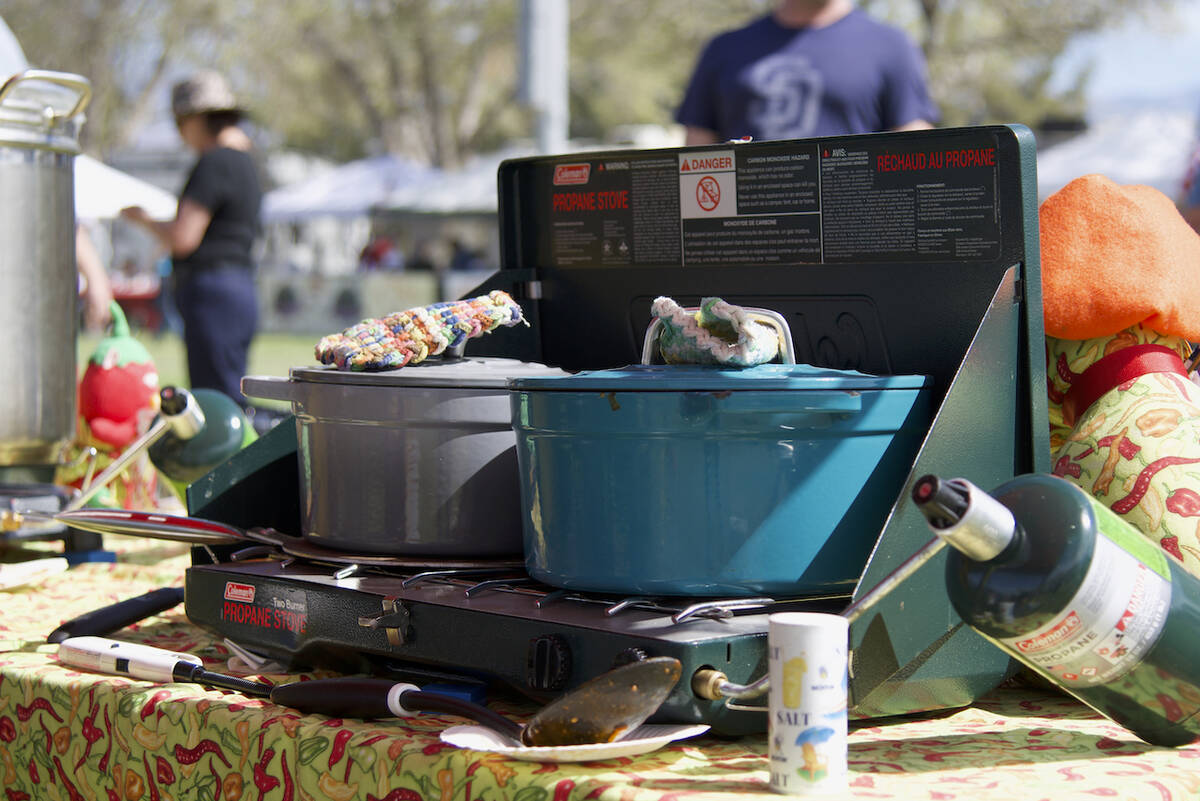 Cooks prepare their red chili before presenting it to the chili judges for the ninth annual Sil ...