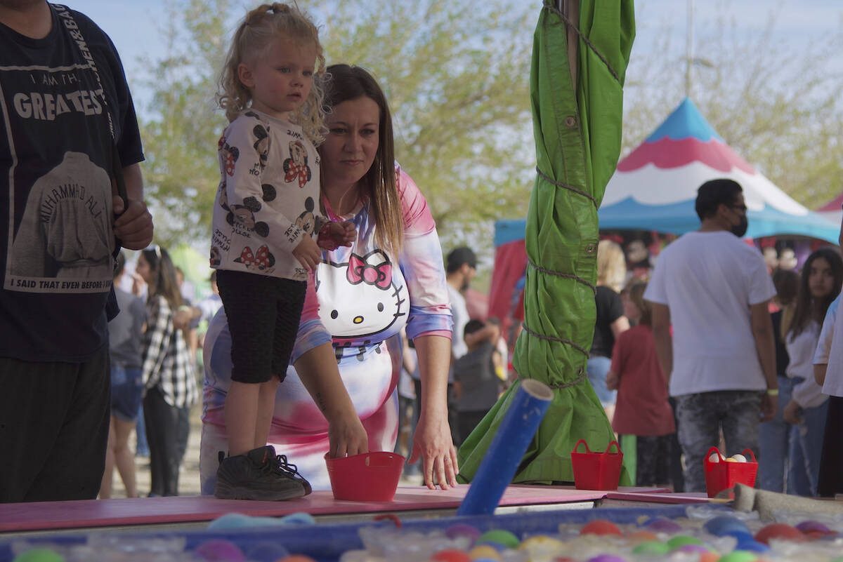 Jimmy Romo/Special to the Pahrump Valley Times A young attendee stands on the a carnival game a ...