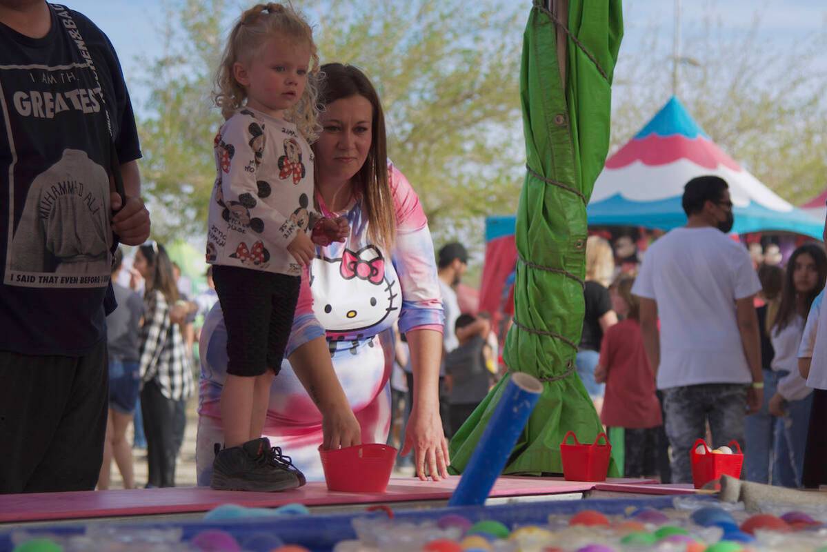 Jimmy Romo/Special to the Pahrump Valley Times A young attendee stands on the a carnival game a ...