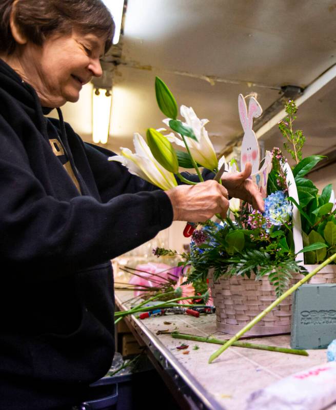 Sue DiBella, co-owner of DiBella Flowers and Gifts, prepares an Easter floral arrangement on Tu ...