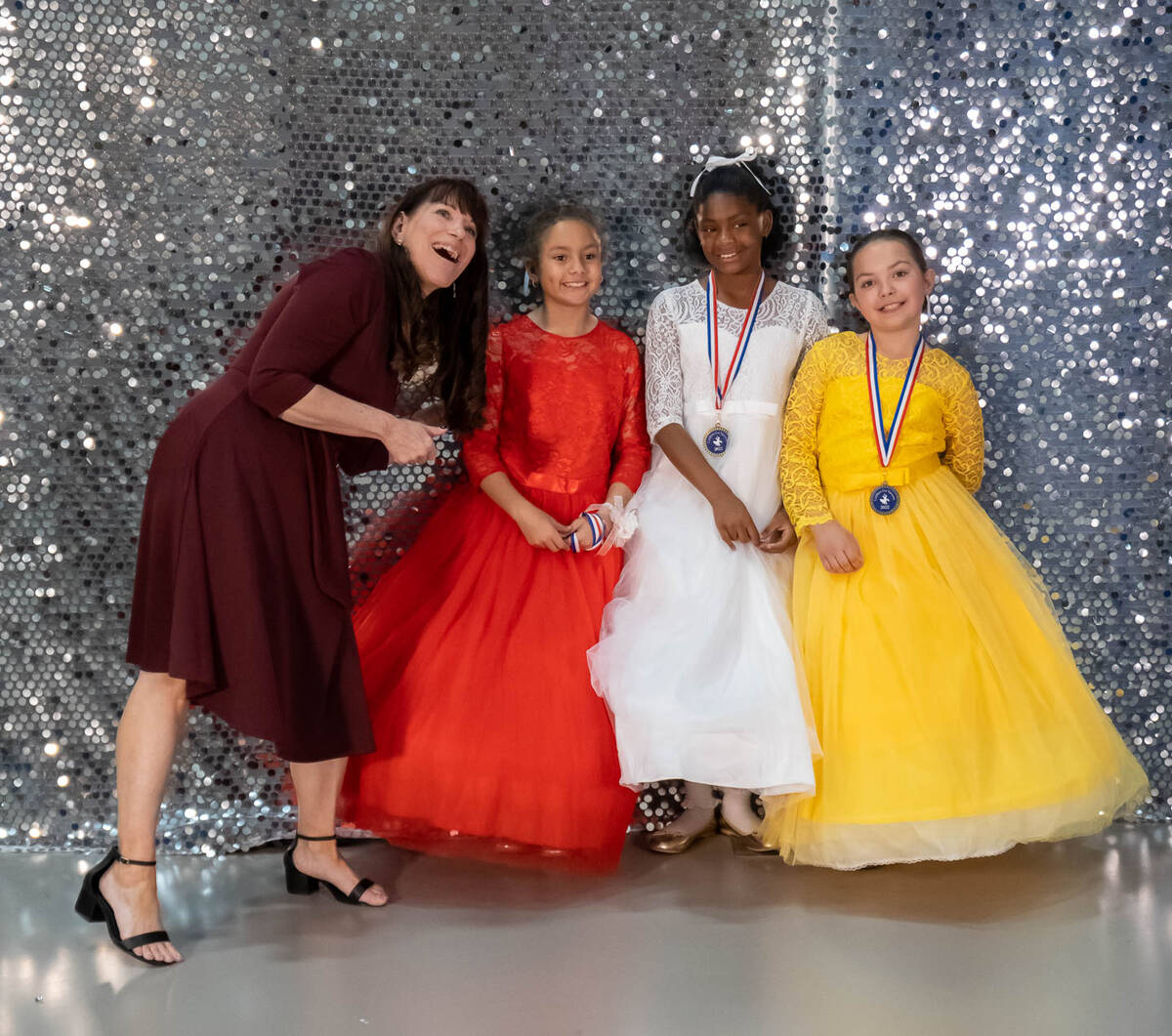 J.G. Johnson Elementary Debbie Carle poses with three of her students at the cotillion on Satur ...