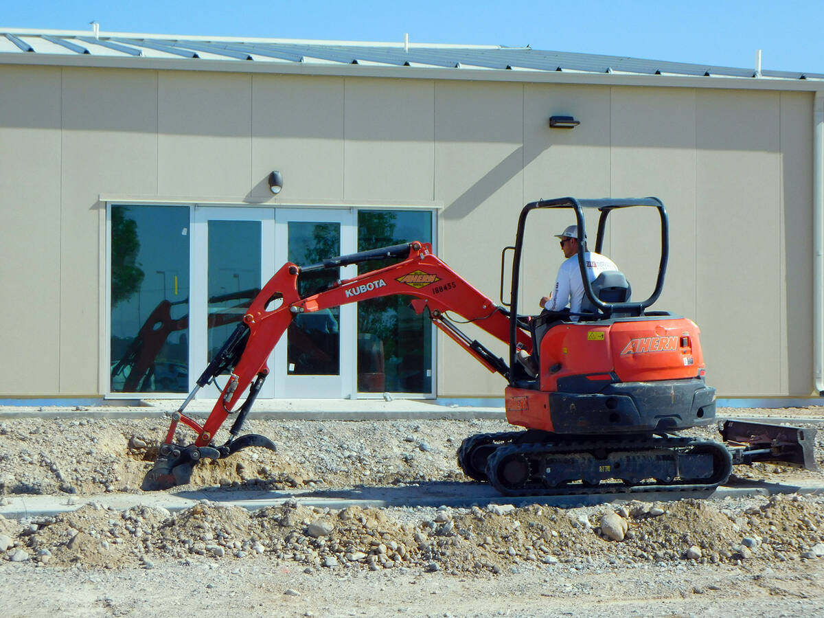 Robin Hebrock/Pahrump Valley Times A construction worker can be seen moving dirt in front of th ...
