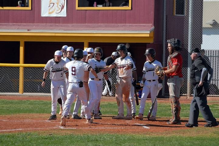 Horace Langford Jr./Pahrump Valley Times Colby Tiller (9) reaching home plate to celebrate with ...