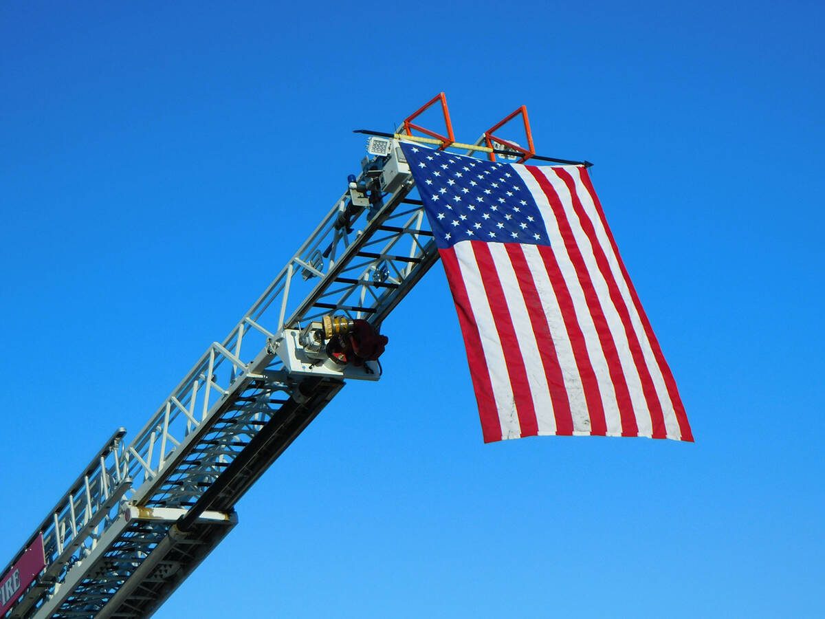 Robin Hebrock/Pahrump Valley Times The Pahrump Fire and Rescue crew hoisted an American Flag on ...
