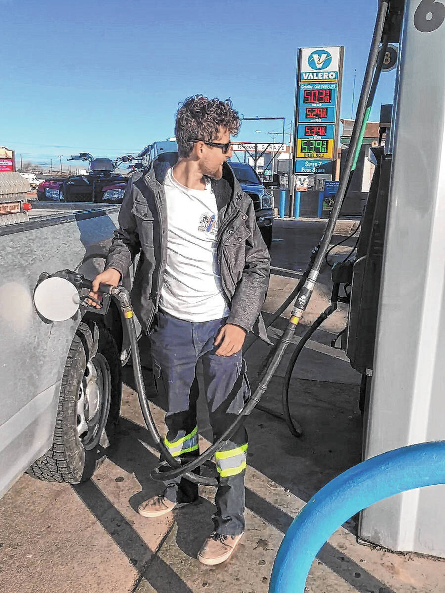 (Charity Wessel/Times-Bonanza) Brandon Ferguson pumps gas at Valero in Tonopah in March 2022 wh ...