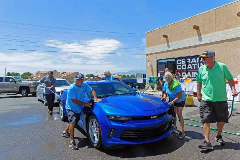 Robin Hebrock/Pahrump Valley Times Volunteers are shown scrubbing down a vehicle during the Sle ...