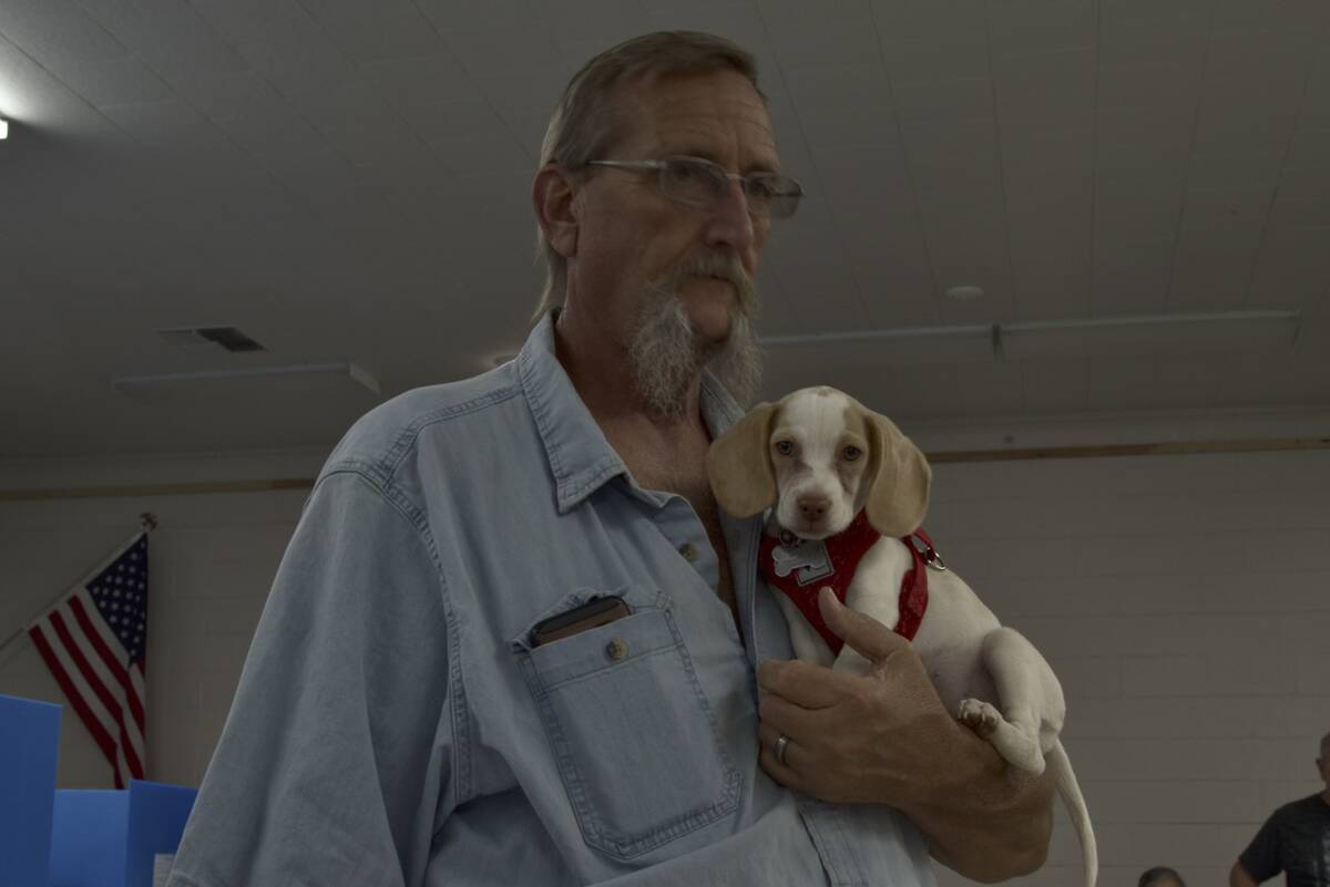 Minor Adam holding his puppy in Pahrump's Bob Ruud Community Center were locals cast their ball ...