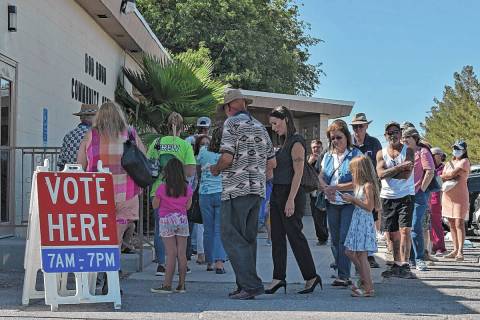 Voters outside Pahrump's Bob Ruud Community Center stand in line to be next to cast their ballo ...