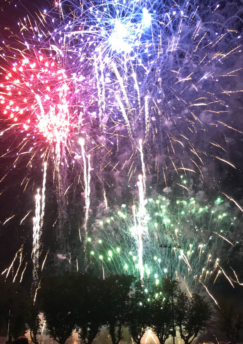 Robin Hebrock/Pahrump Valley Times Blue, red, green and gold fireworks explode above the tree l ...