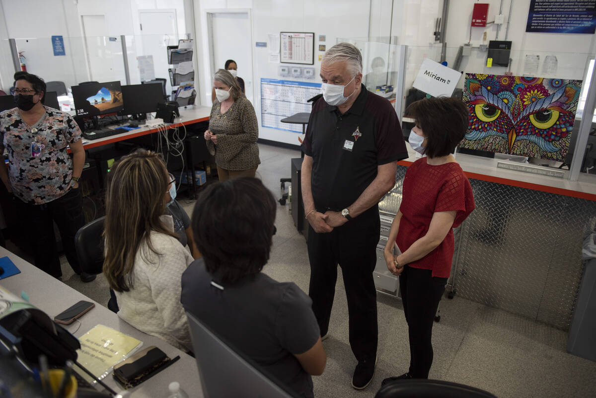 Gov. Steve Sisolak, center, and First Lady Kathy Sisolak, right, talk to staff at the Southern ...