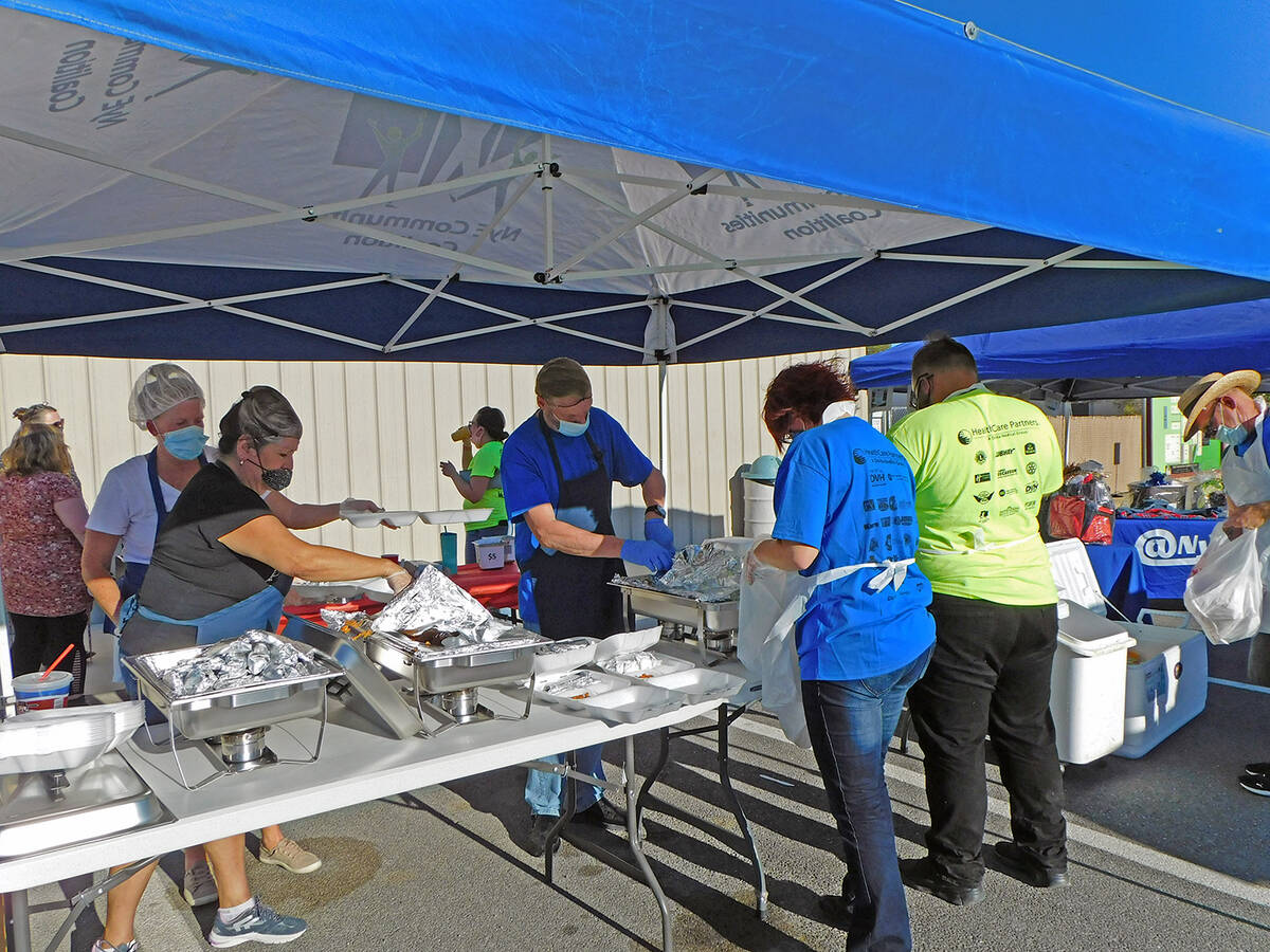 Robin Hebrock/Pahrump Valley Times In this file photo, a team of volunteers works to fill to-go ...