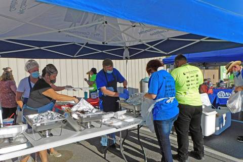 Robin Hebrock/Pahrump Valley Times In this file photo, a team of volunteers works to fill to-go ...