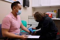 Anoh Ratsamy receives the monkeypox vaccine from registered nurse Christopher Hansen at the Arl ...
