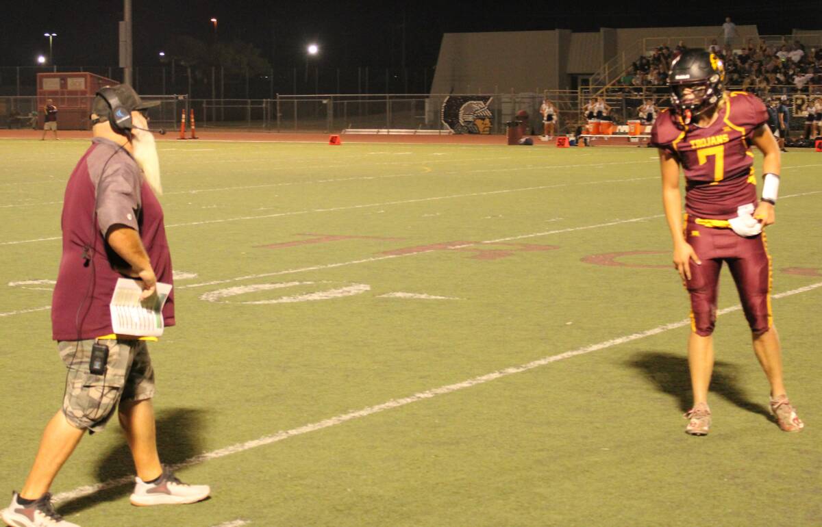 Danny Smyth/Pahrump Valley Times Senior quarterback Scott Oscarson (7) gets the play call from ...