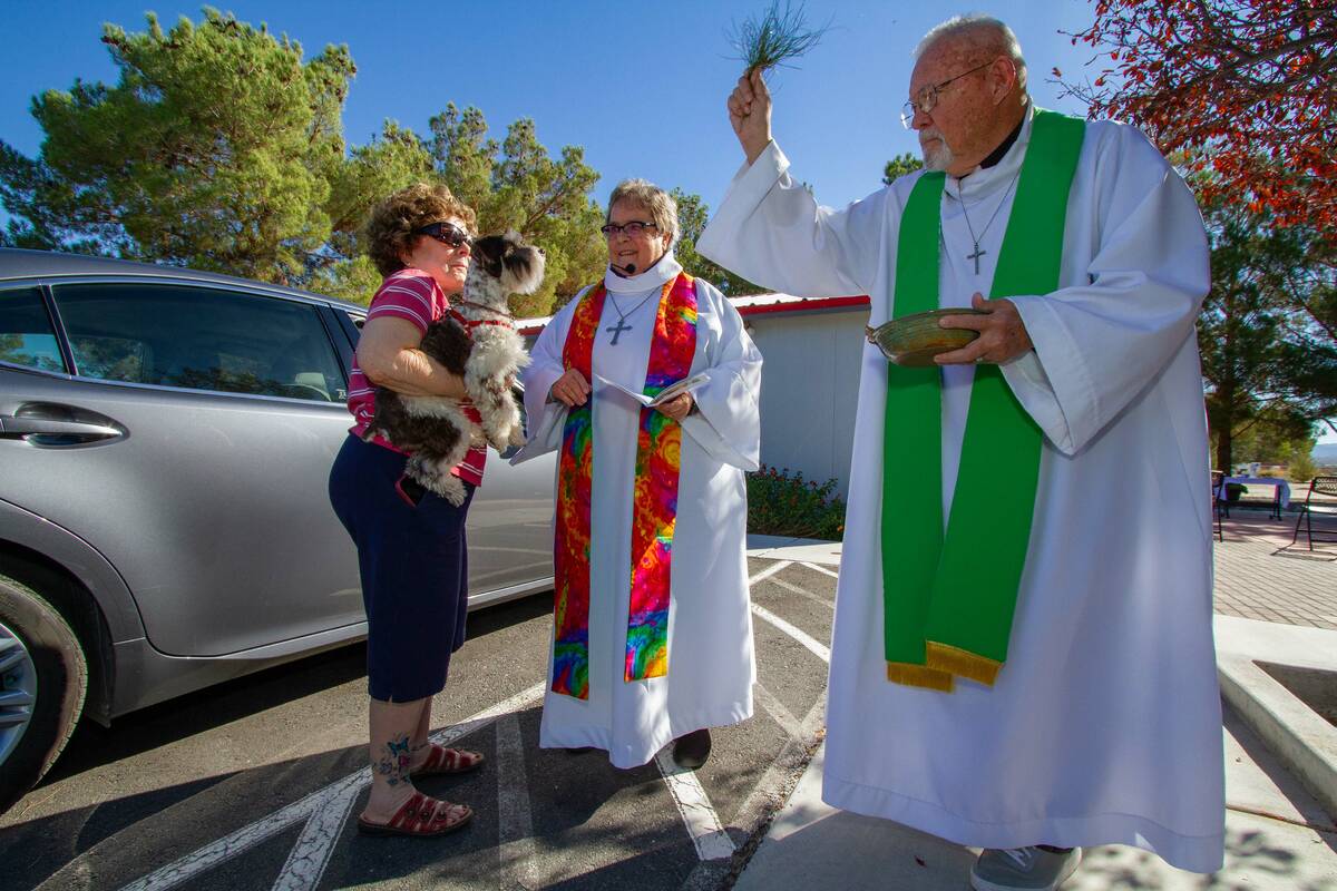 Judy brought three Airedales to be blessed. The Rev. Lola Culbreath and Father John McClatchy a ...