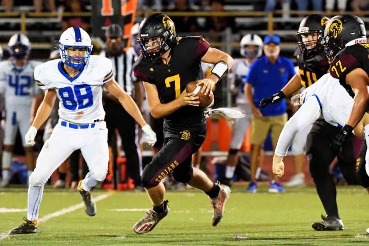 Peter Davis/Pahrump Valley Times Senior quarterback Scott Oscarson scrambles with the ball dur ...