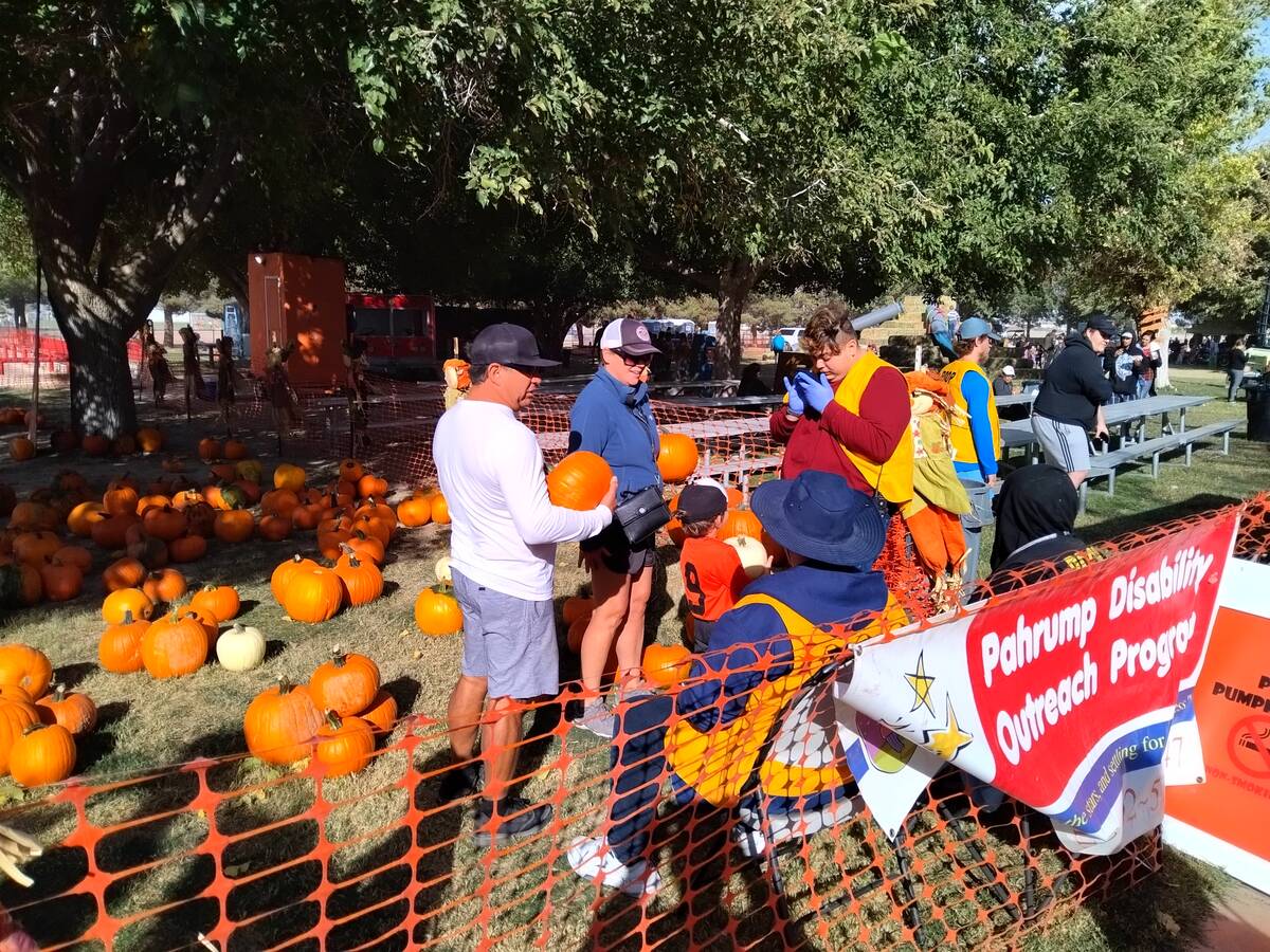 Selwyn Harris/Pahrump Valley Times A family scouts for pumpkins at Pumpkin Days, an annual fund ...