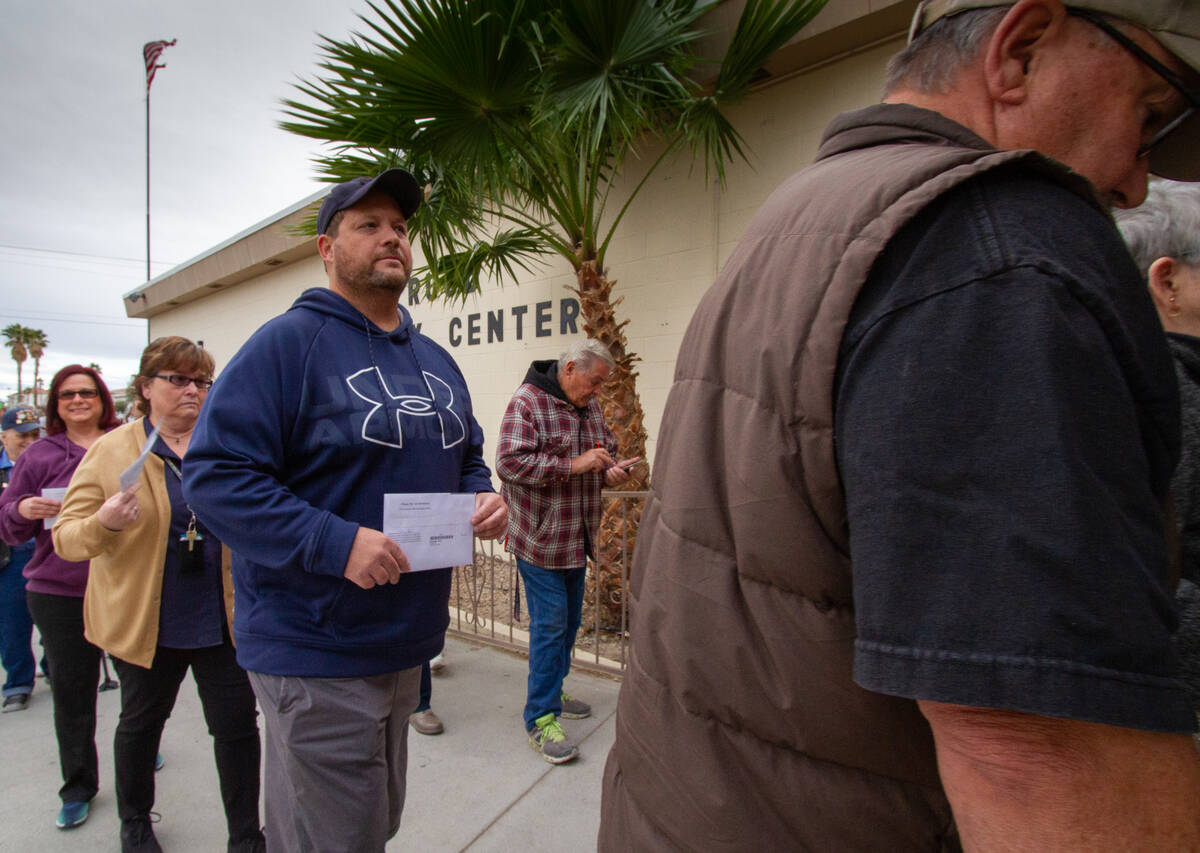 John Clausen/Special to the Pahrump Valley Times Pahrump voters carry their paper ballots to th ...
