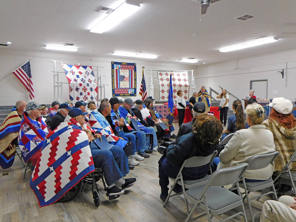 Robin Hebrock/Pahrump Valley Times At left, a group of Quilts of Valor recipients listen as a f ...