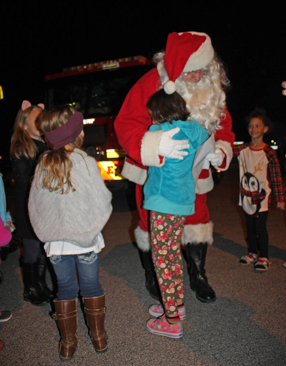 Robin Hebrock/Pahrump Valley Times Santa Claus is shown embracing valley youngsters at a previo ...