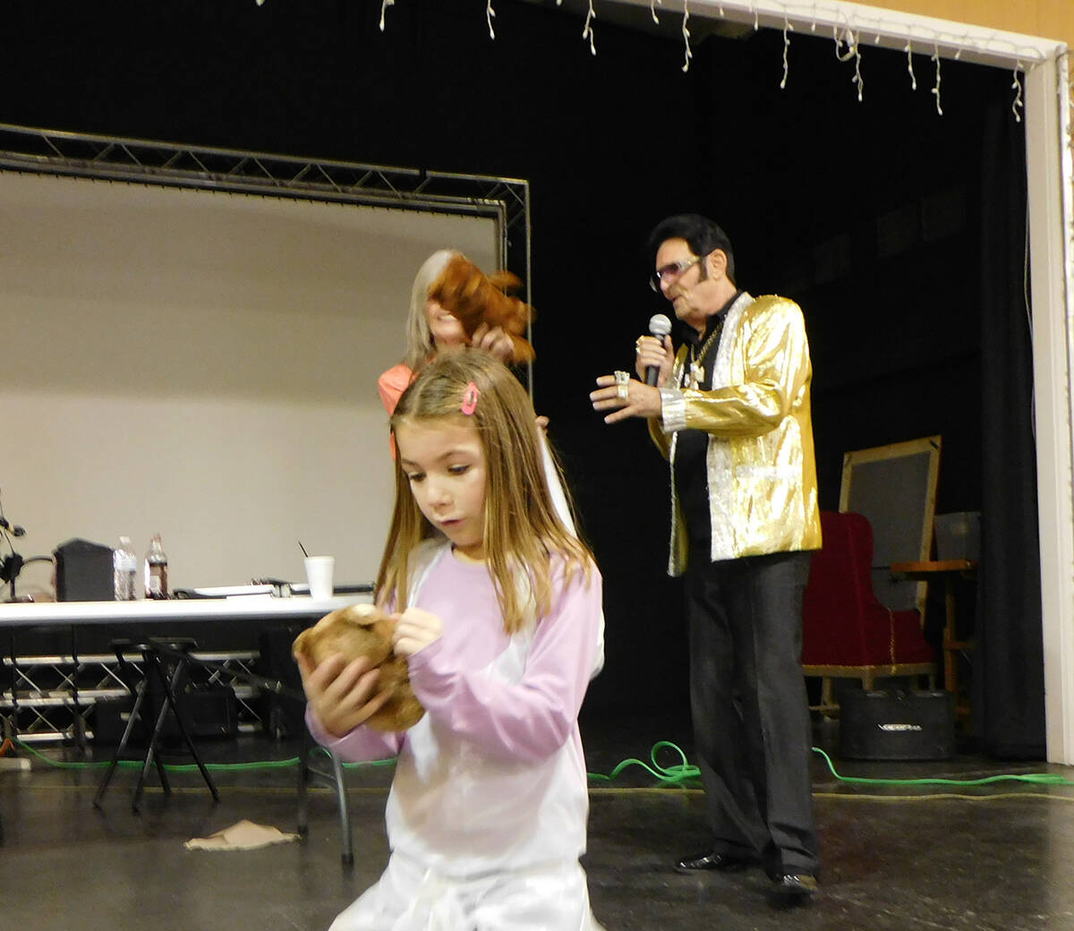 Robin Hebrock/Pahrump Valley Times A young girl admires the teddy bear she was given by Elvis i ...