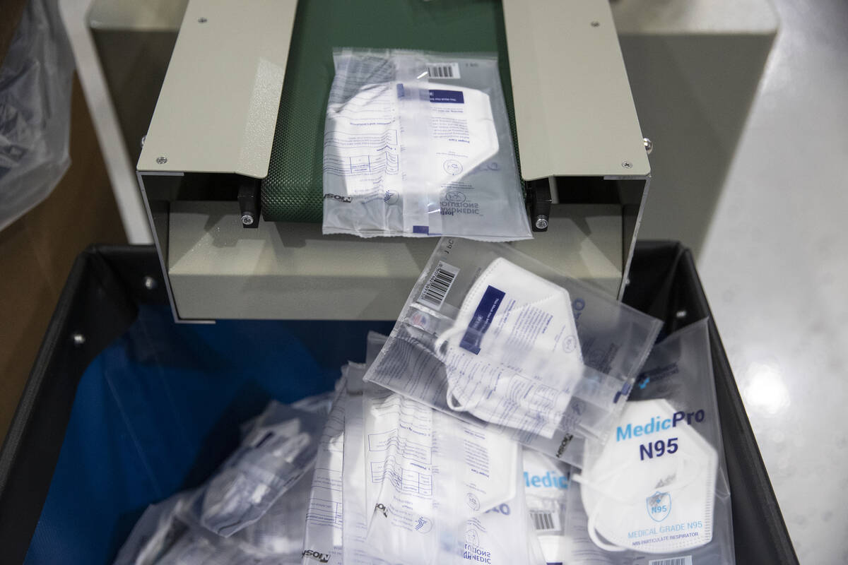 A machine packages individual N95 masks at the PandMedic Solutions headquarters in Las Vegas on ...
